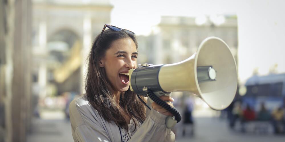 Woman shouting out on loudspeaker