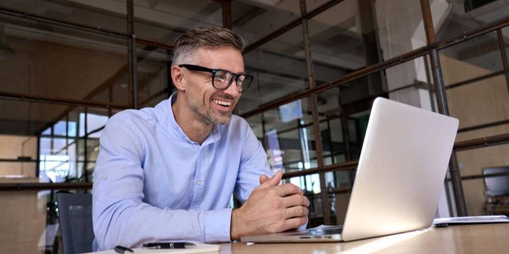 Man smiling at laptop