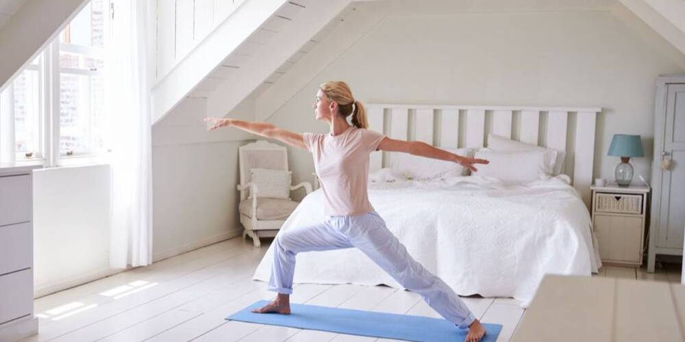 woman exercising yoga before work