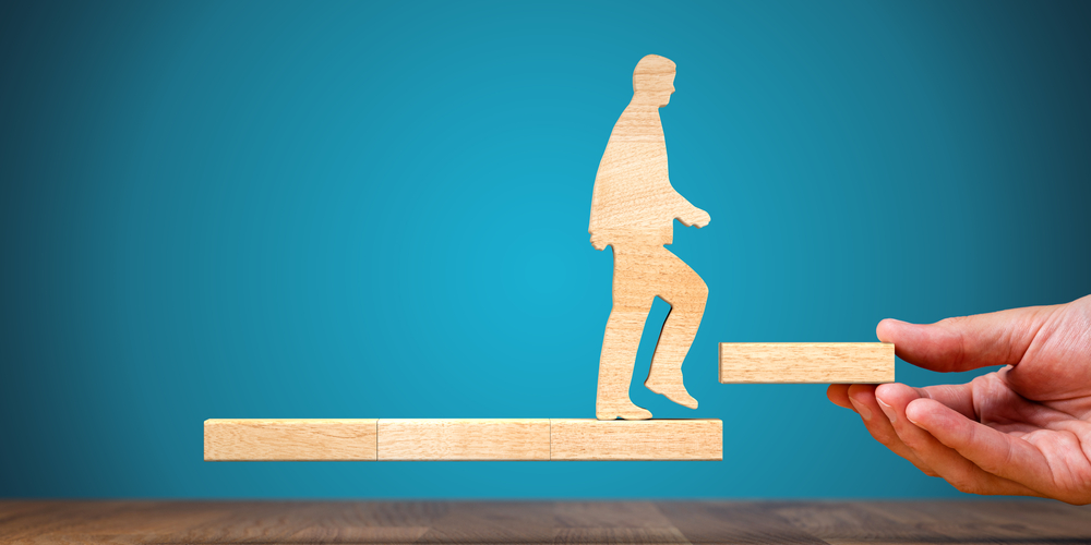 Man balancing on wooden step