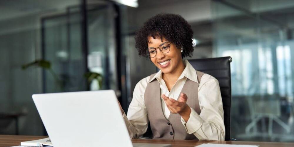 Smiling woman looking at laptop 