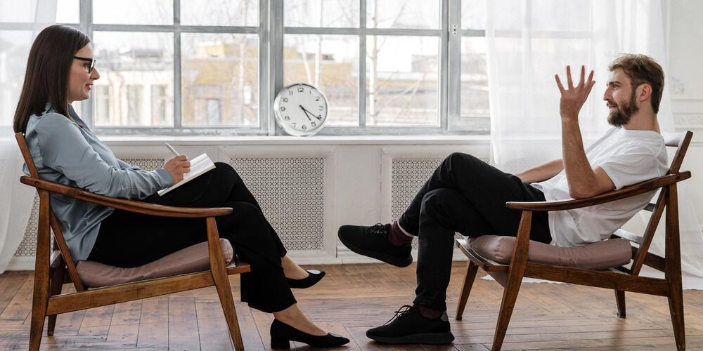 man and woman discussing performance at work